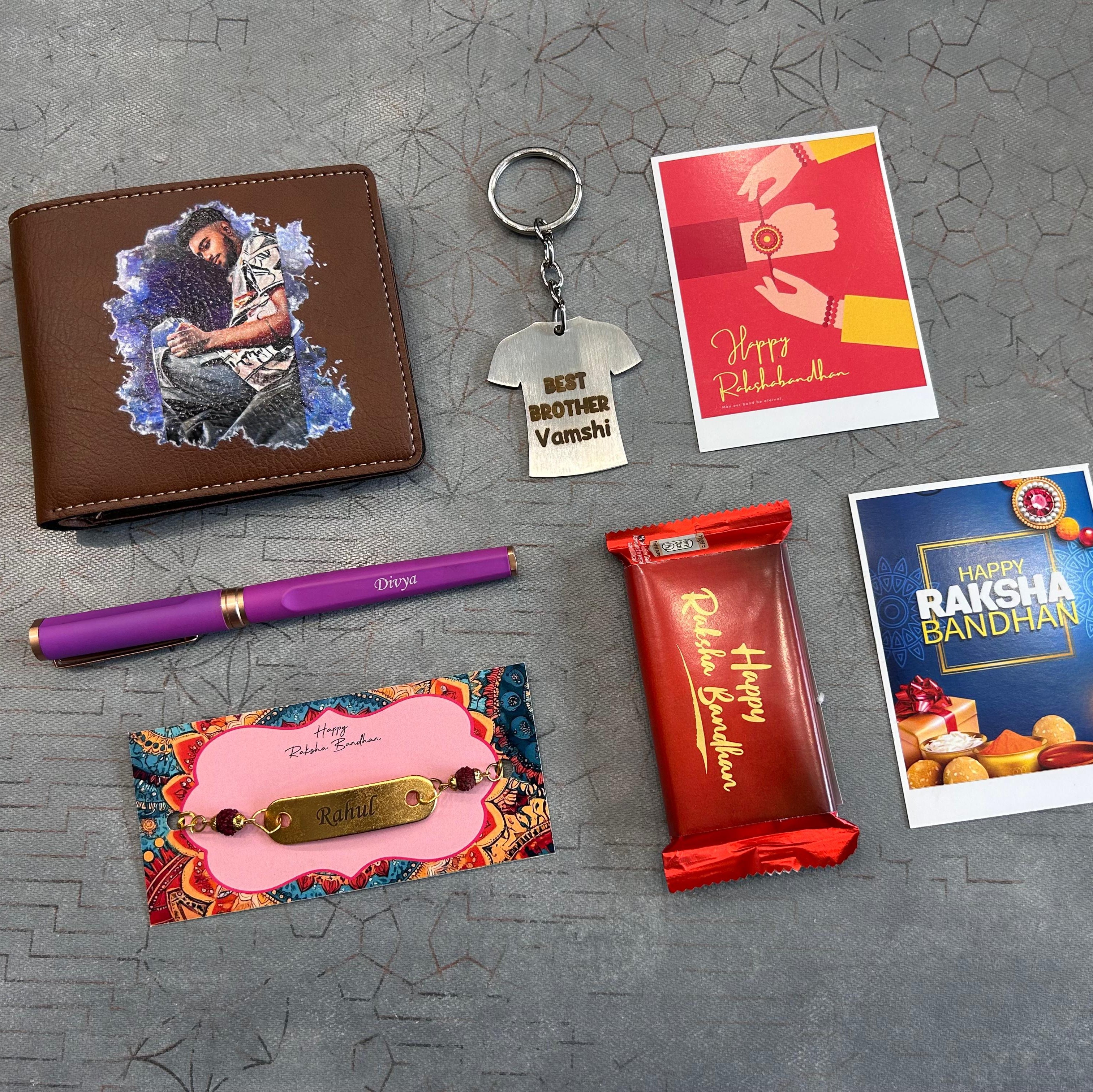 Collection of Raksha Bandhan-themed gifts including a wallet, keychain, pen, card, and chocolate on a textured surface. - The Gifting Era