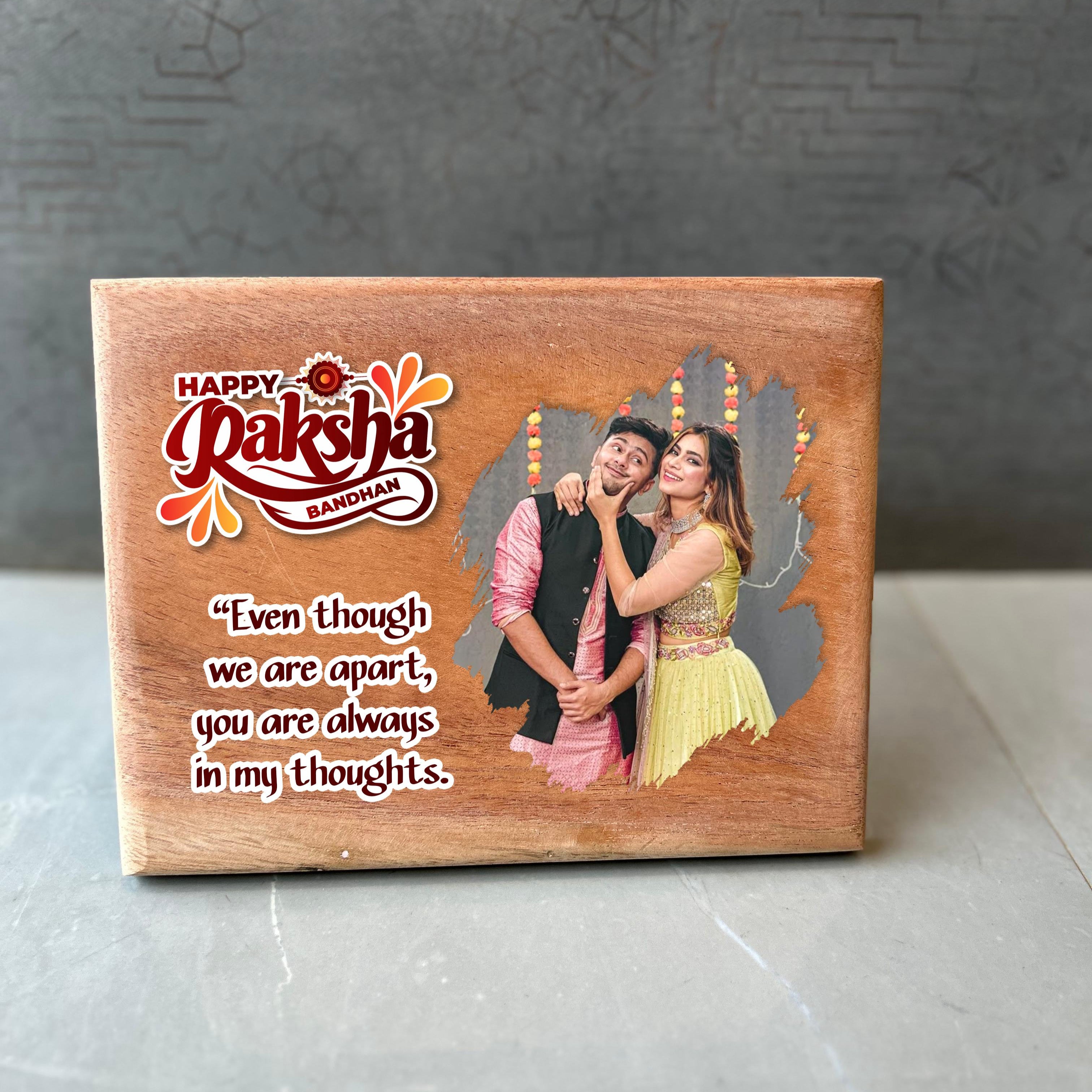 Wooden photo frame with a couple's photo and Raksha Bandhan message on a gray background - The Gifting Era