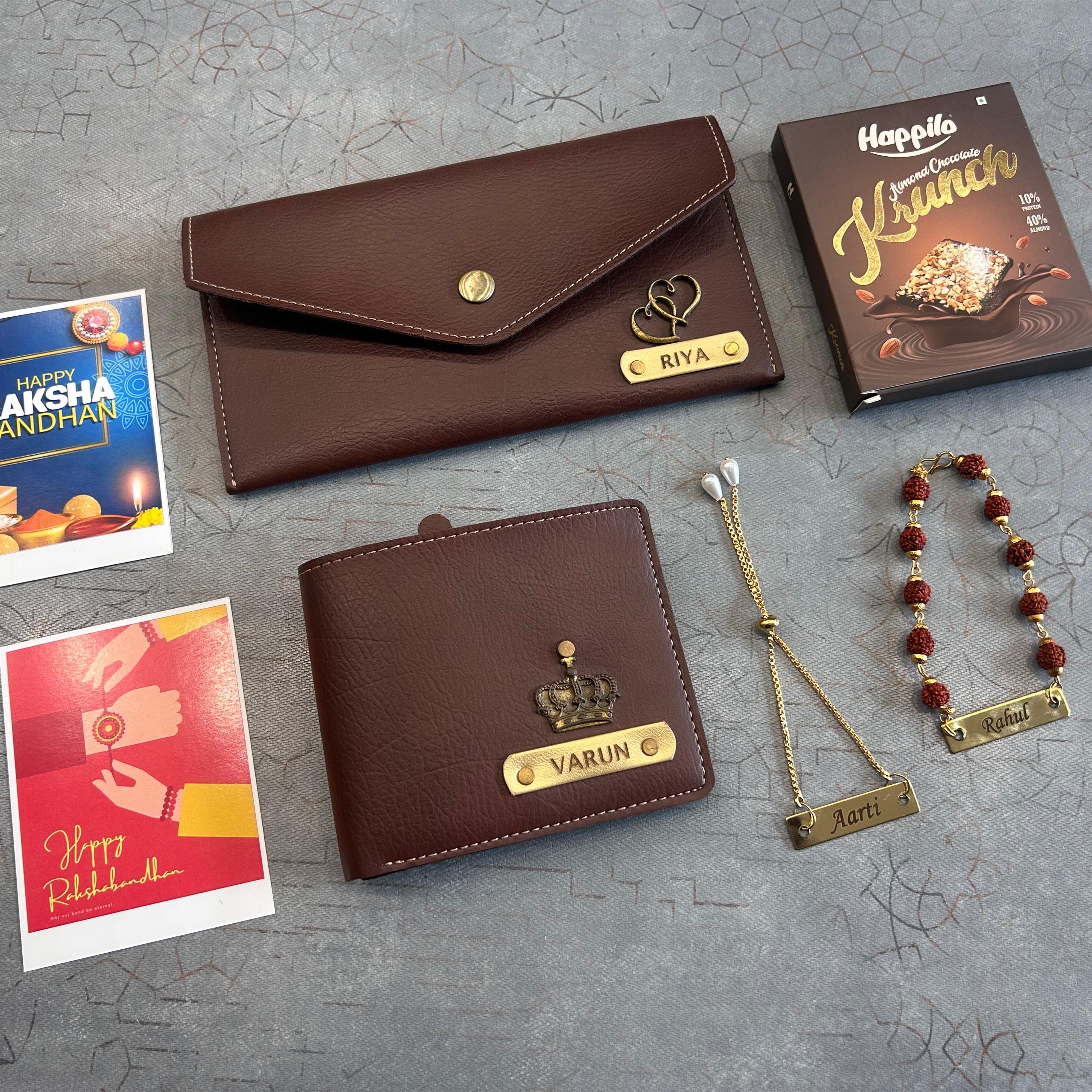 Brown leather wallets, jewelry, and cards on a textured gray surface - The Gifting Era