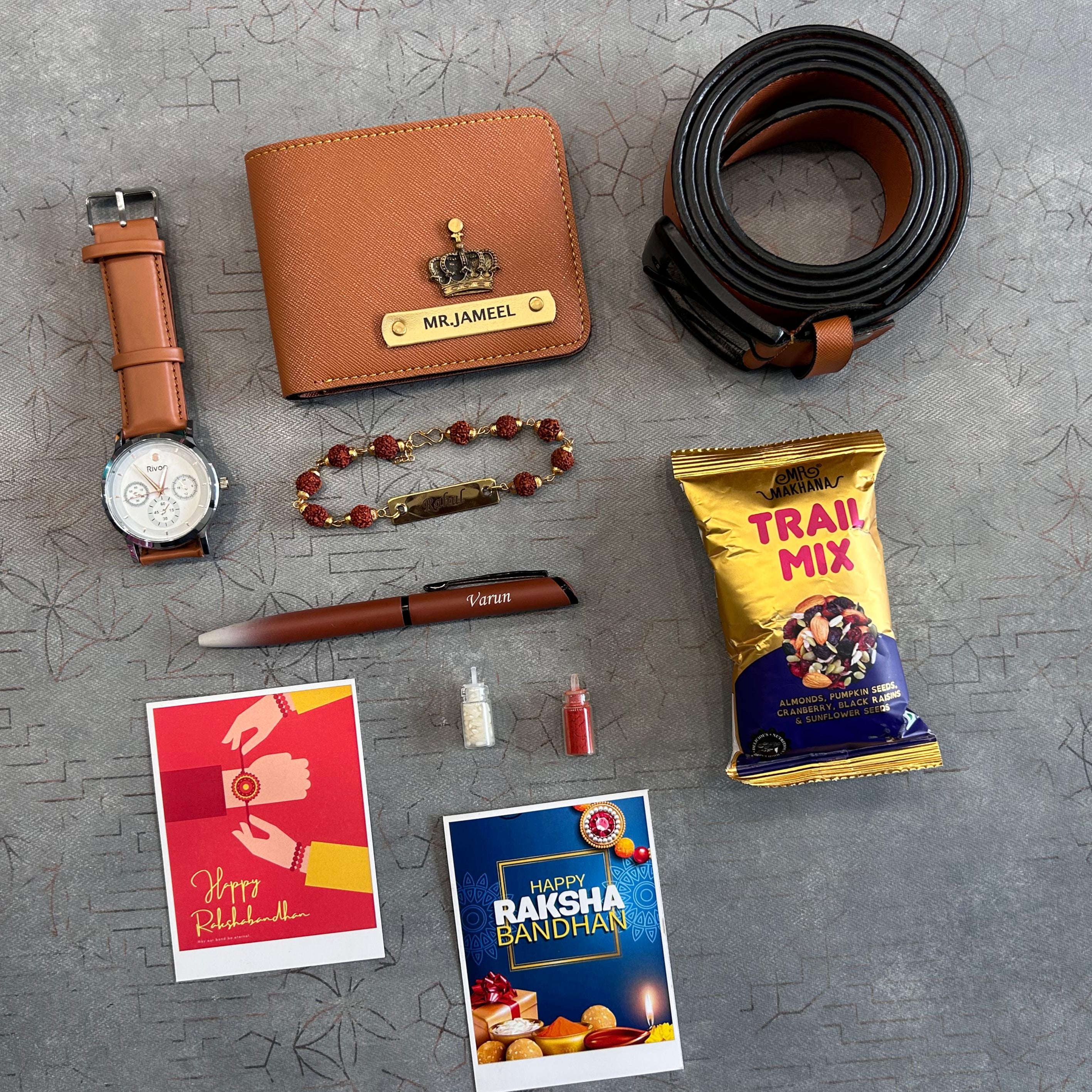 Collection of items including a wallet, watch, belt, pen, cards, and trail mix on a textured surface. - The Gifting Era