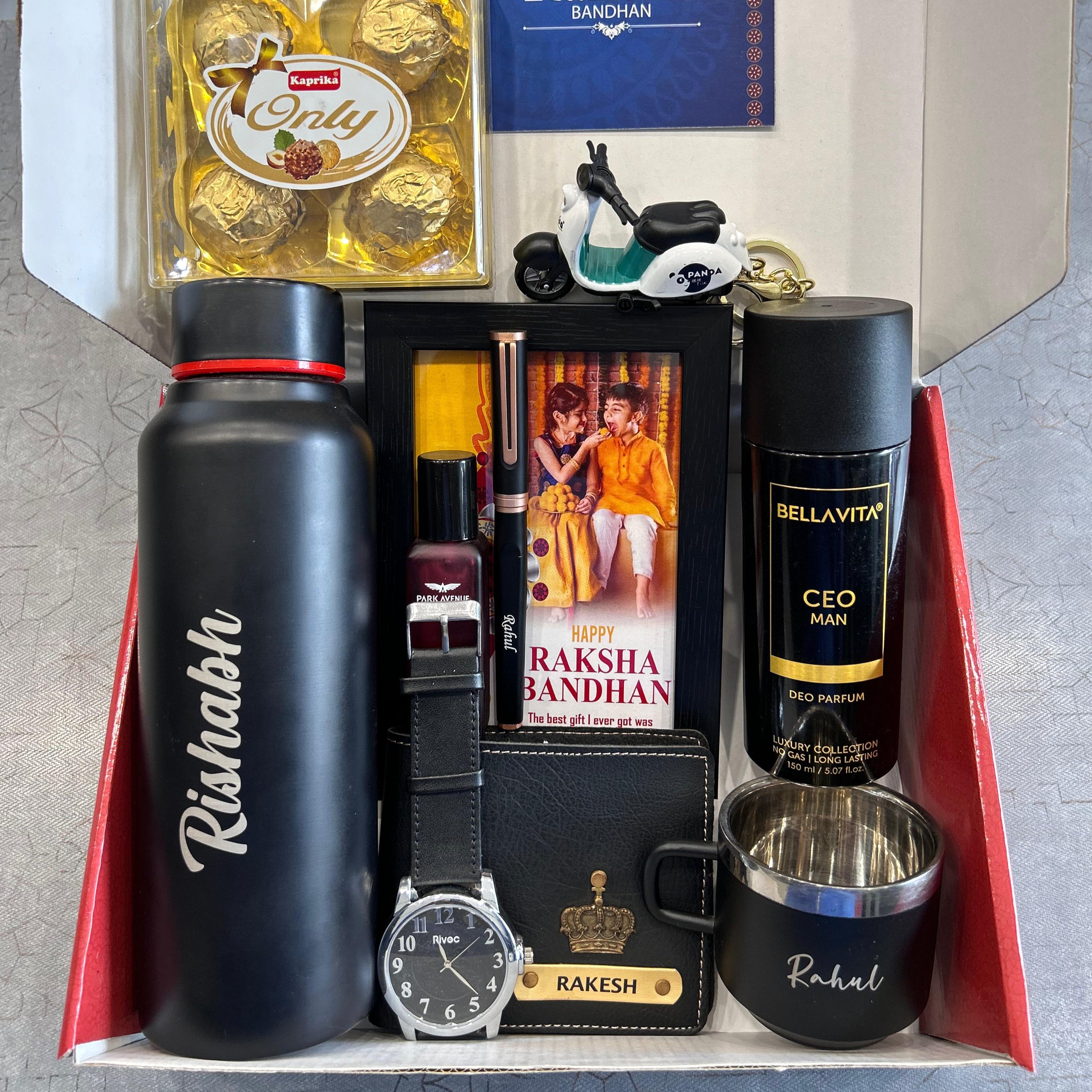 Gift set with Rakhi, chocolate, water bottle, watch, and other items in a box. - The Gifting Era
