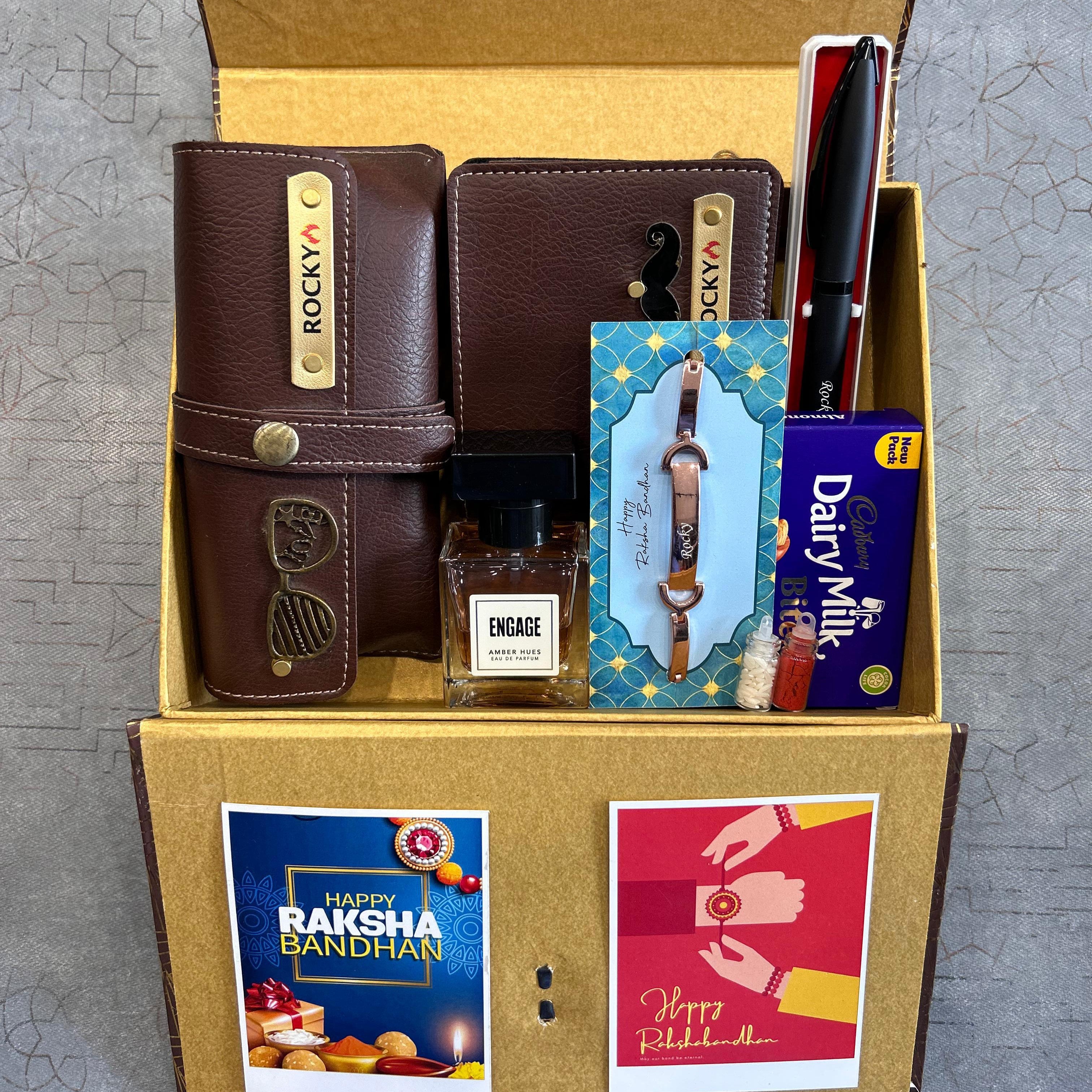 Gift set with Rakhi, watch, and other items in a box on a textured surface - The Gifting Era
