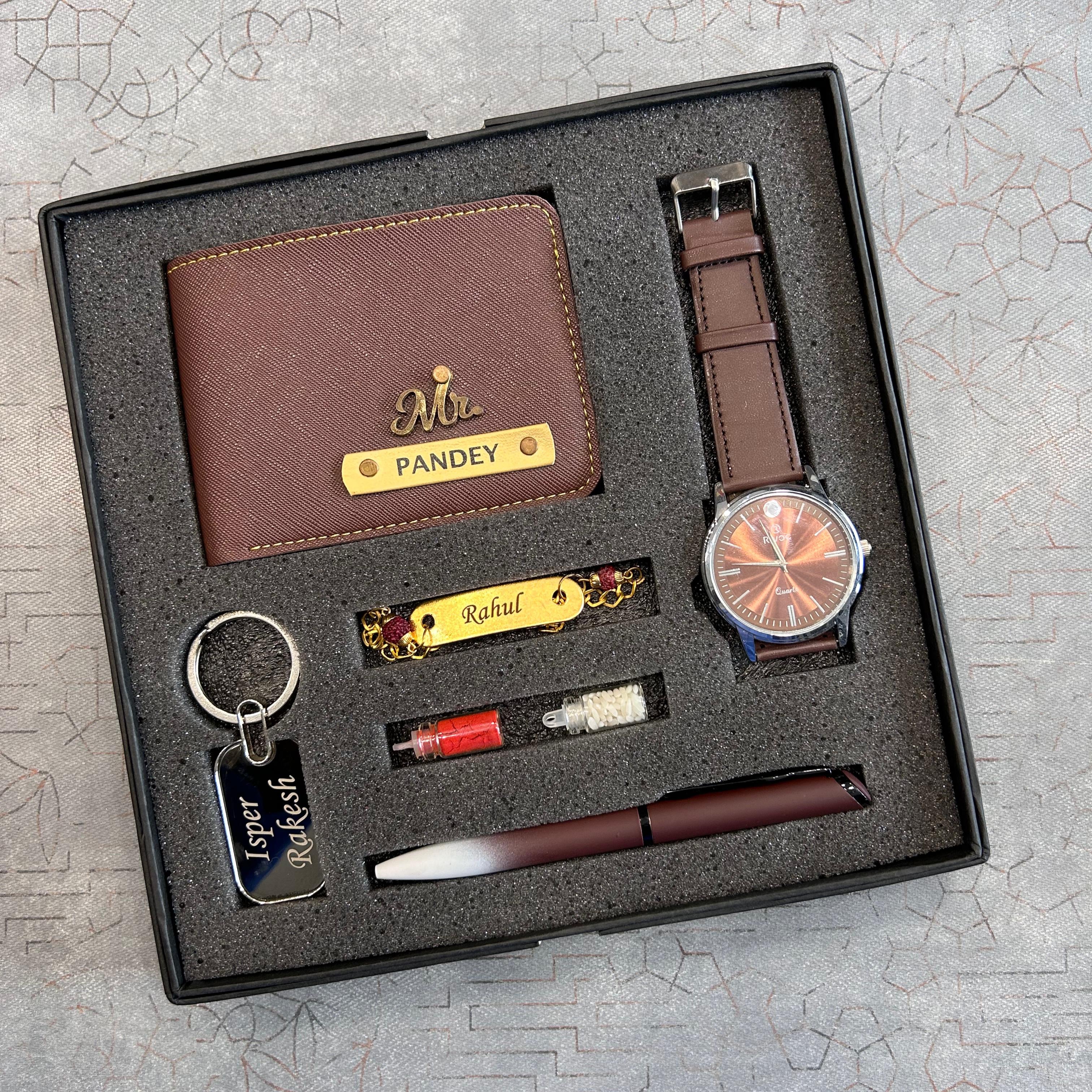 Gift set with brown wallet, watch, keychain, pen, and lighter in a box on a textured surface.  The Gifting Era