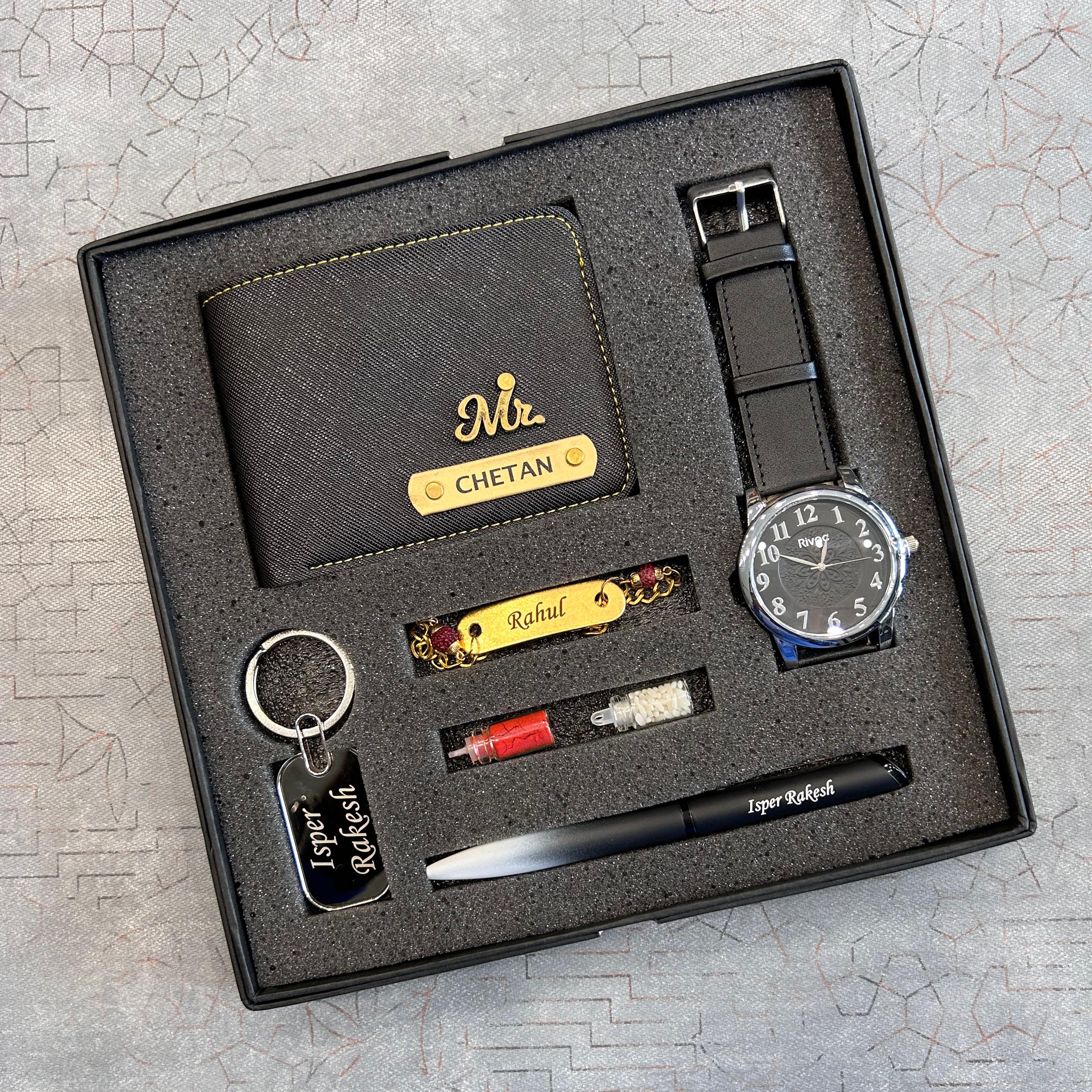 Groomsmen gift set with wallet, watch, keychain, and other items in a box on a textured surface.  The Gifting Era