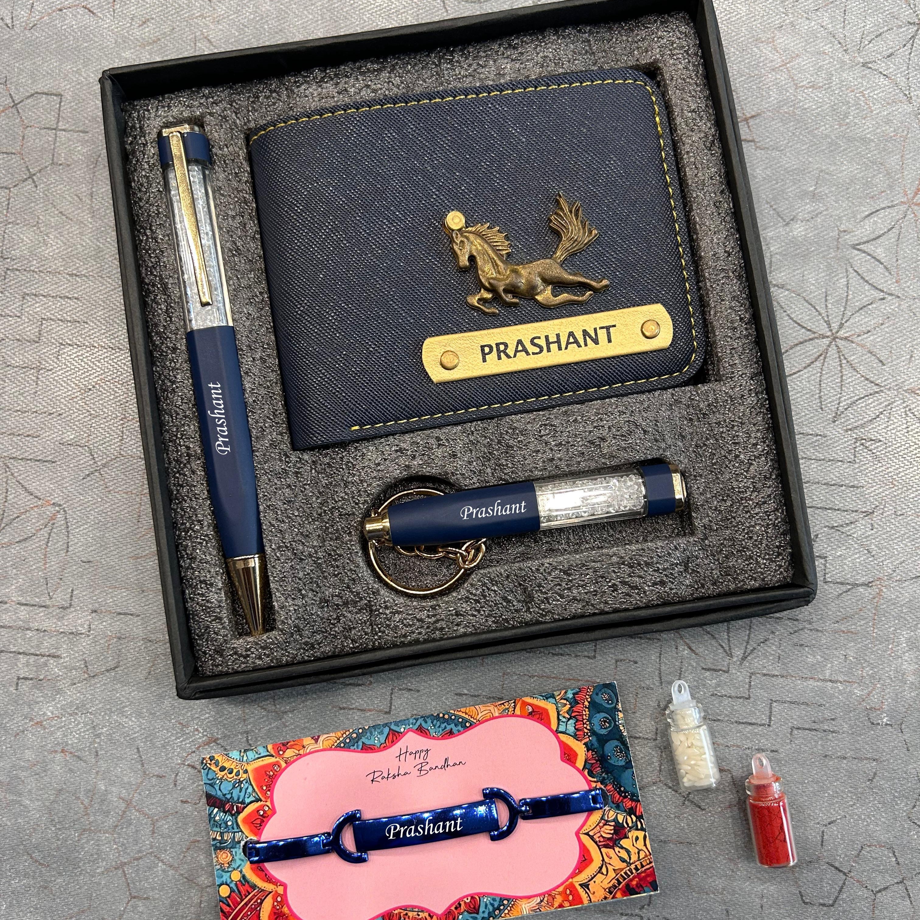 Gift set with navy blue wallet, pen, keychain, and card on a textured surface  - The Gifting Era