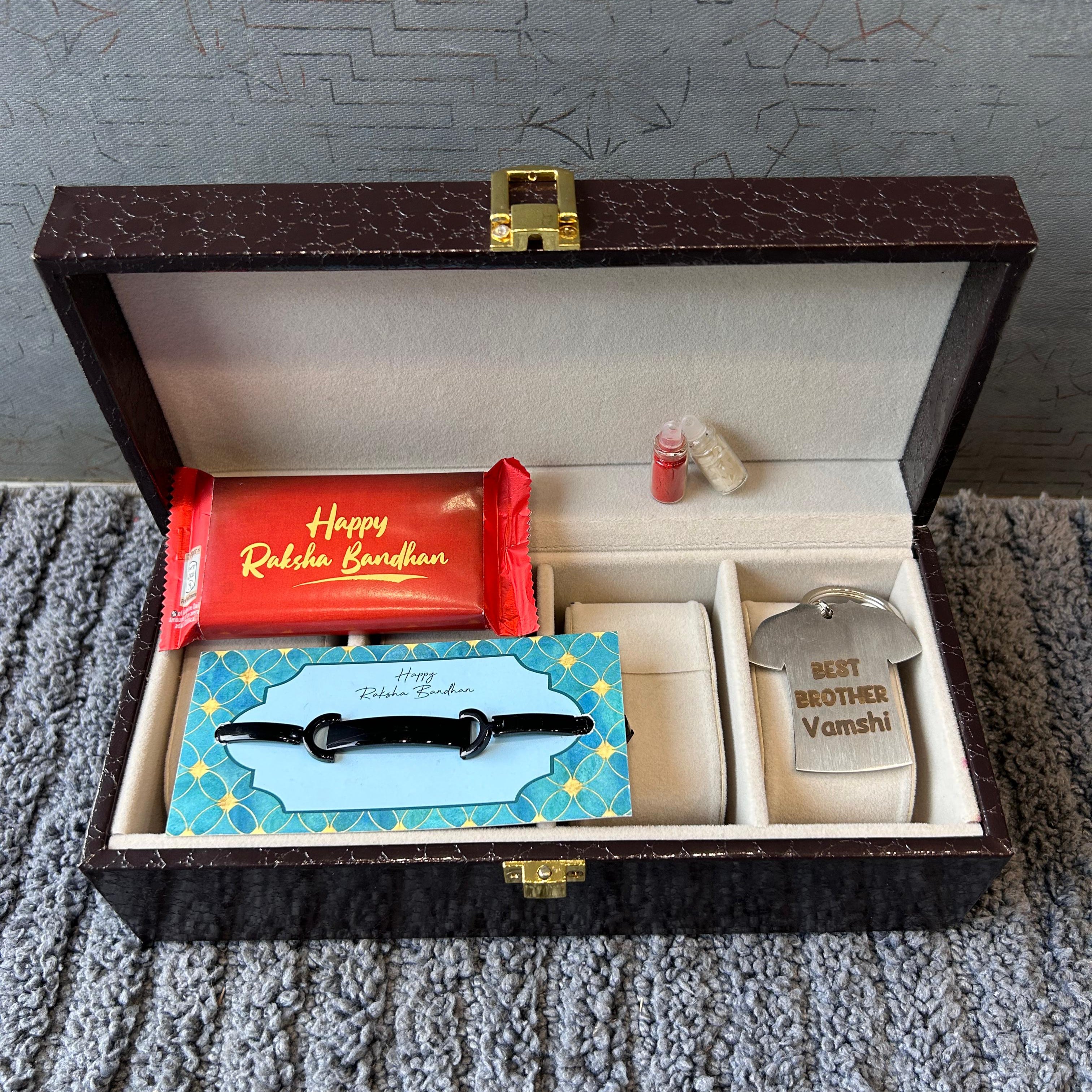Gift set with a red card, blue card, and silver container in an open box on a textured surface.  - The Gifting Era