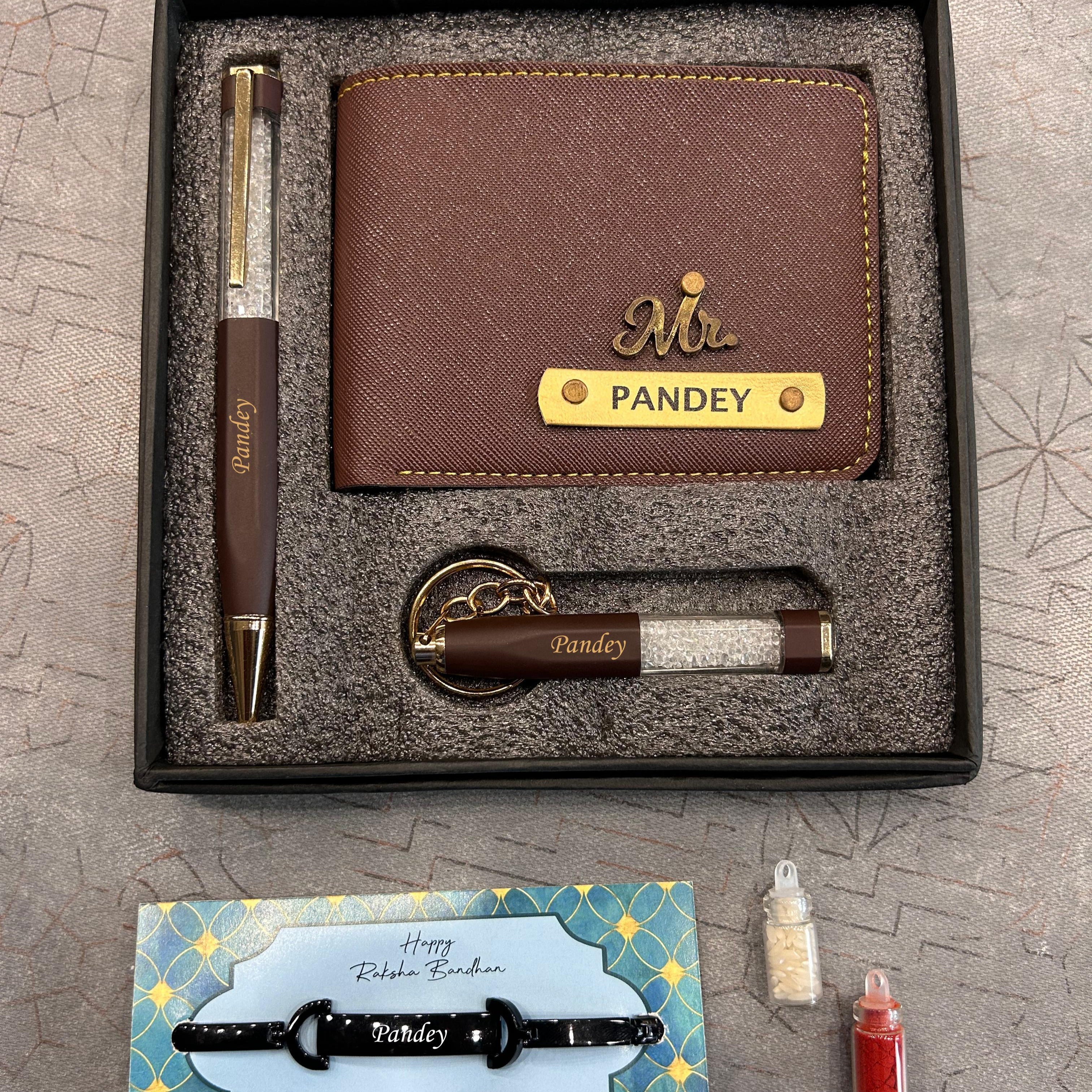 Gift set with brown wallet, pen, keychain, and card on a textured surface  - The Gifting Era
