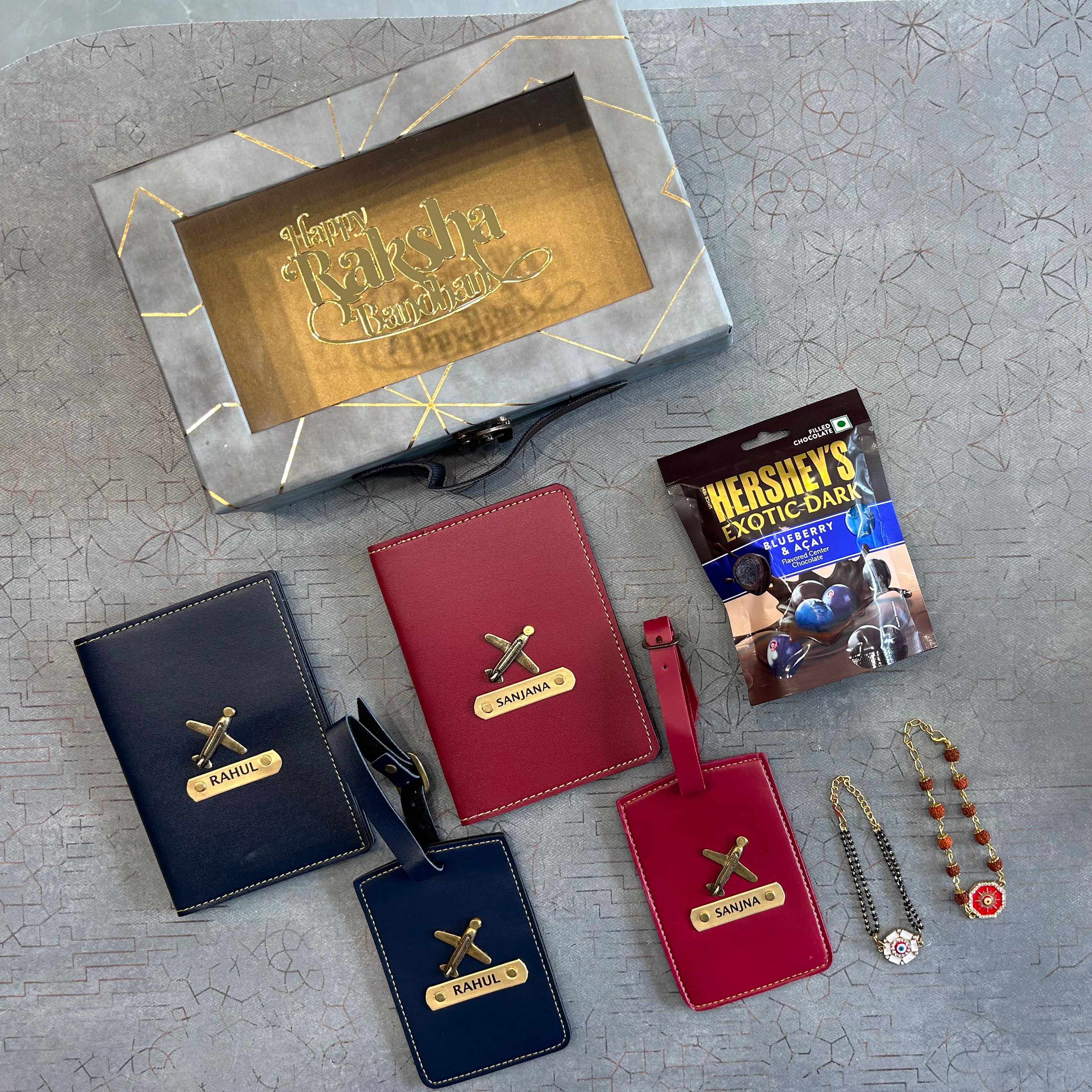 Collection of personalized luggage tags and a Hershey's chocolate bar on a textured surface. - The Gifting Era
