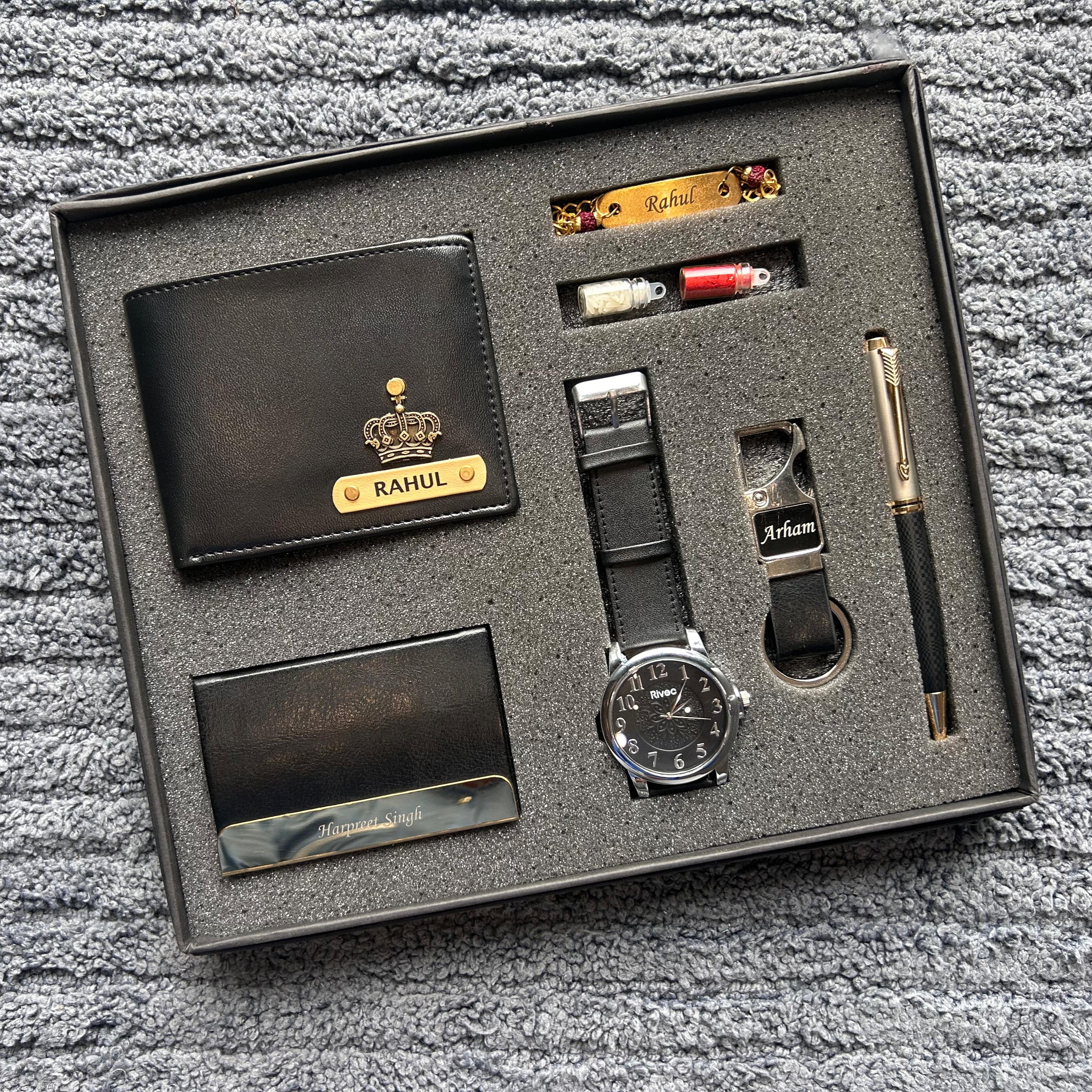 Gift set with wallet, watch, pen, and other items in a box on a textured surface - The gifting Era