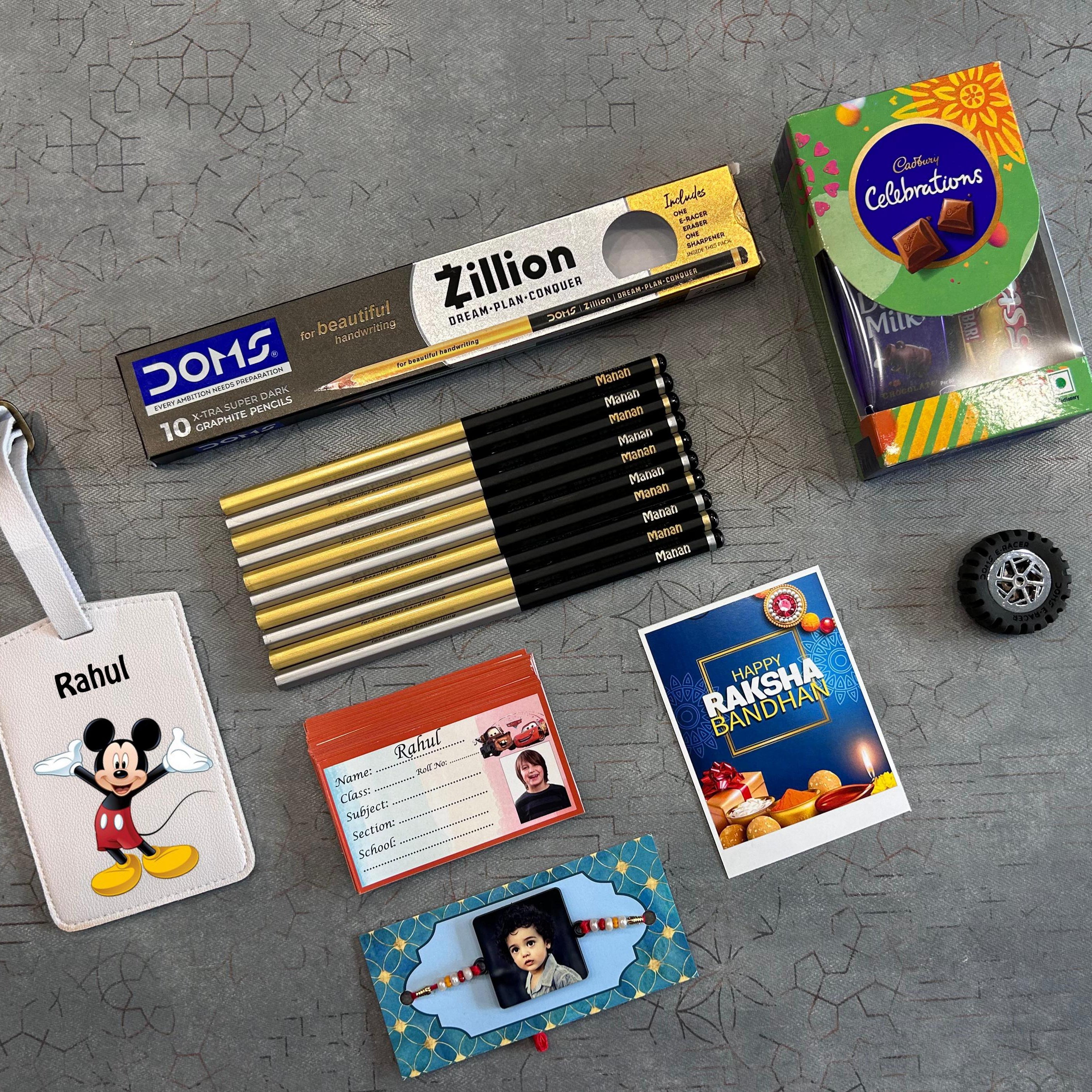 Collection of stationery items and a small toy car on a textured gray surface - The Gifting Era