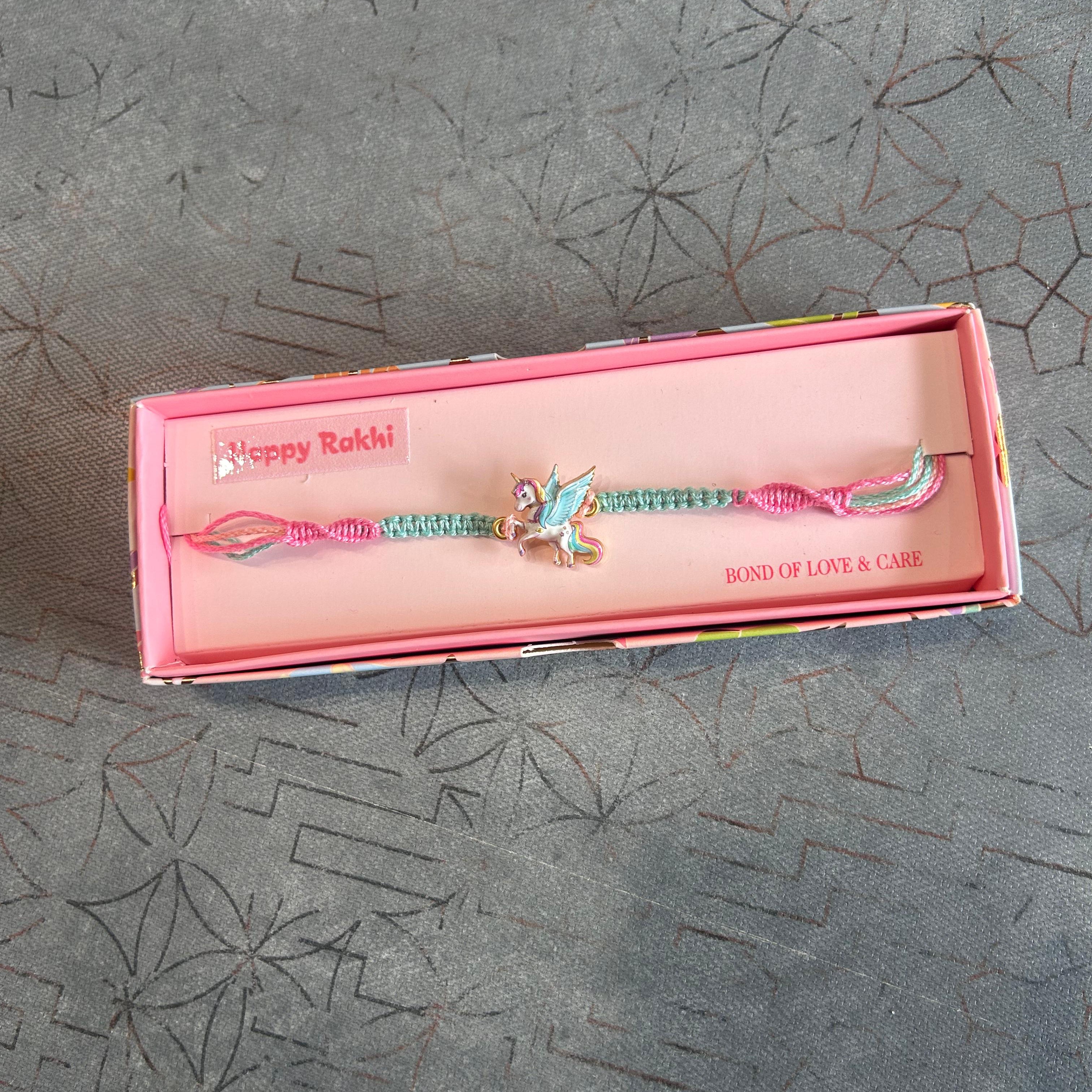 Pink box with a decorative item on a textured gray surface - The Gifting Era