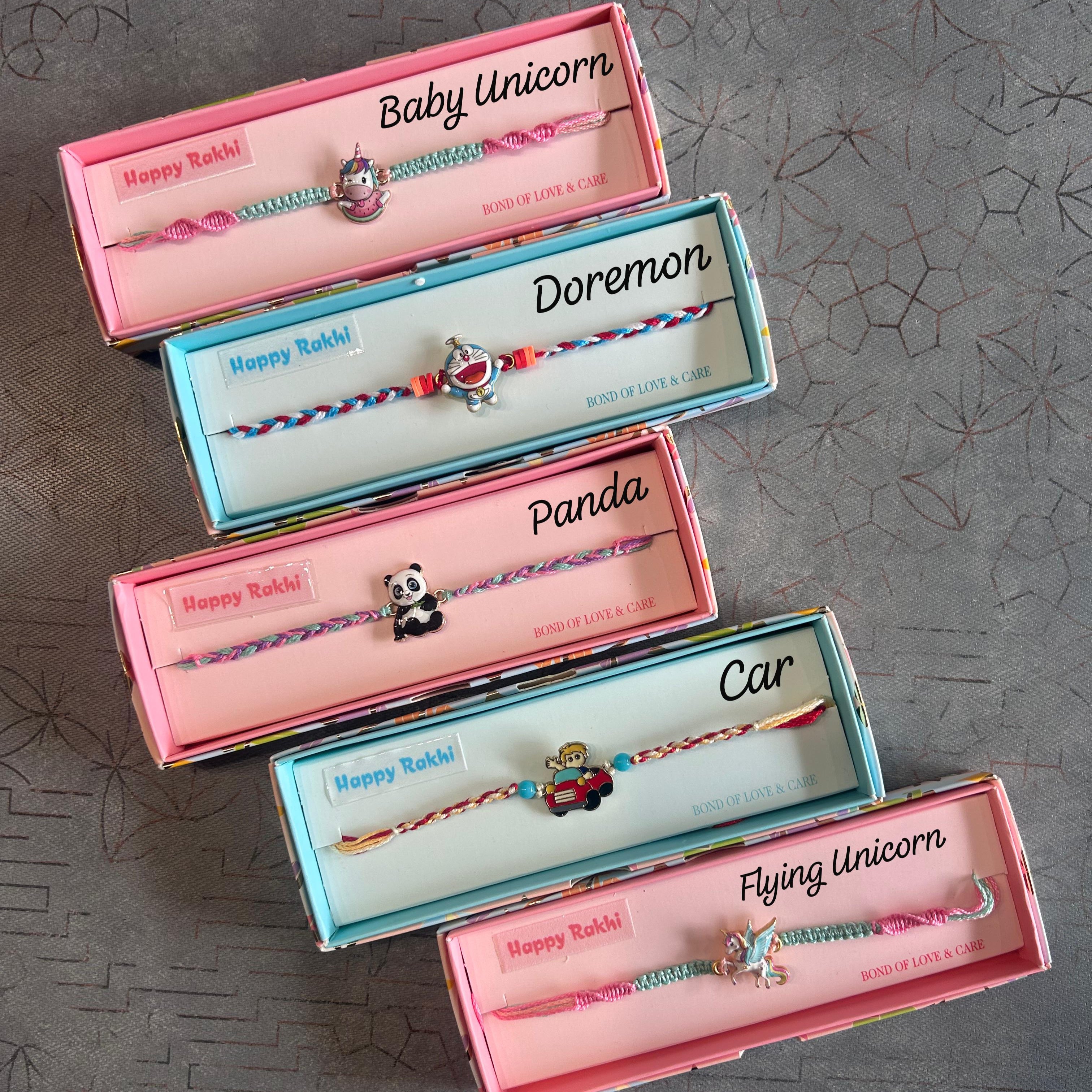 Set of colorful bracelets in branded boxes on a textured surface - The Gifting Era