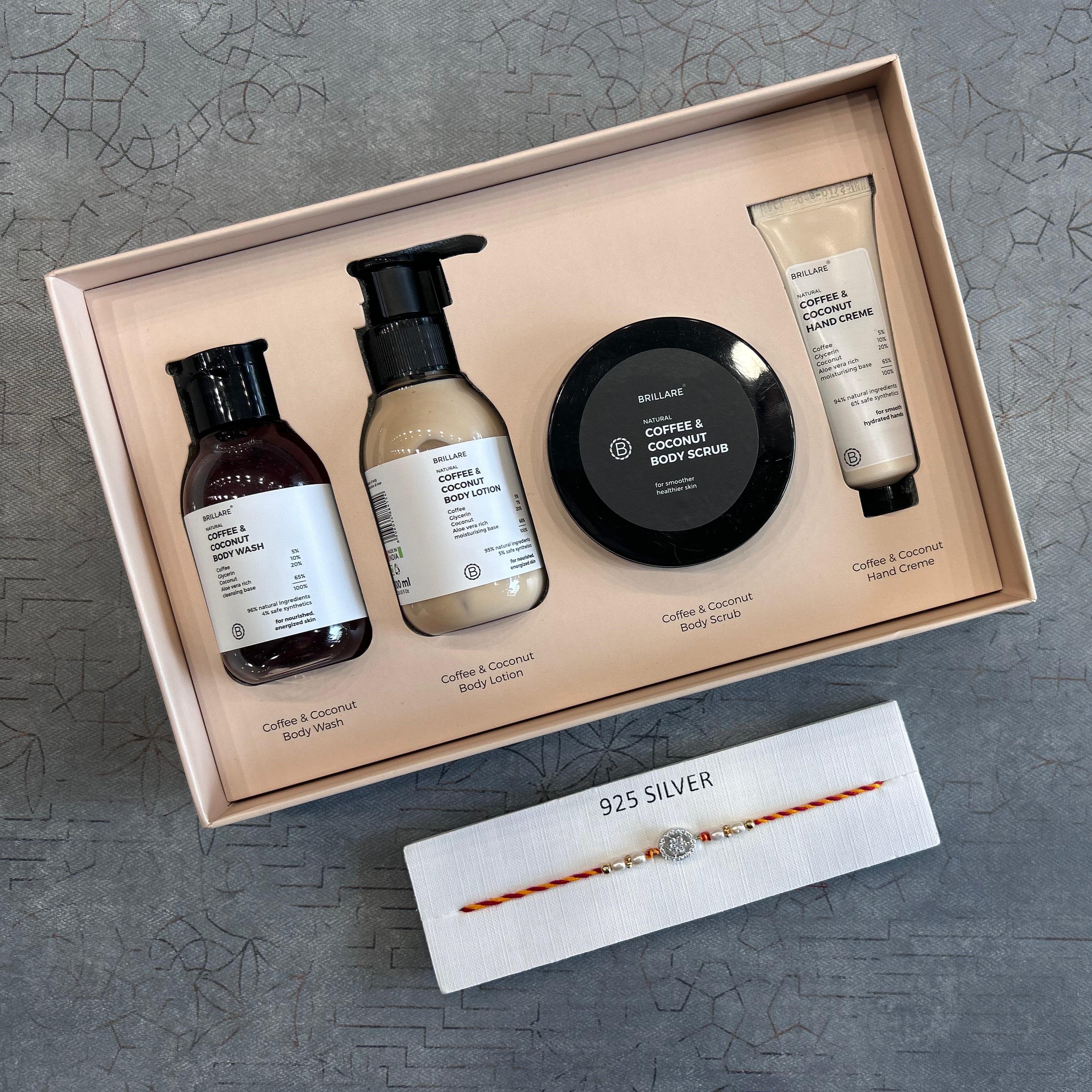 Set of body care products including bottles, a scrub, and a tube in a box on a textured gray surface. - The Gifting Era