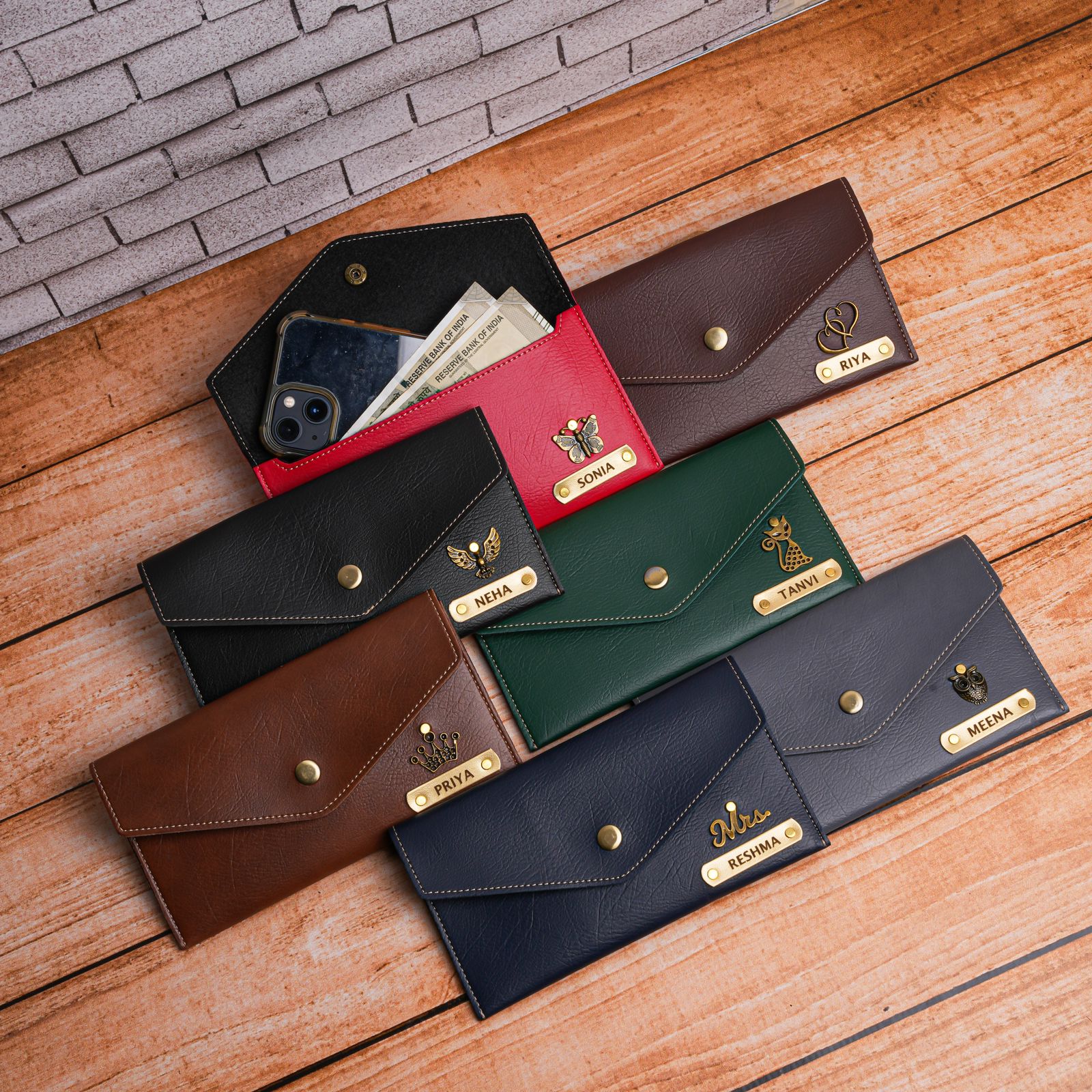 Collection of leather wallets in various colors on a wooden surface. - The Gifting Era