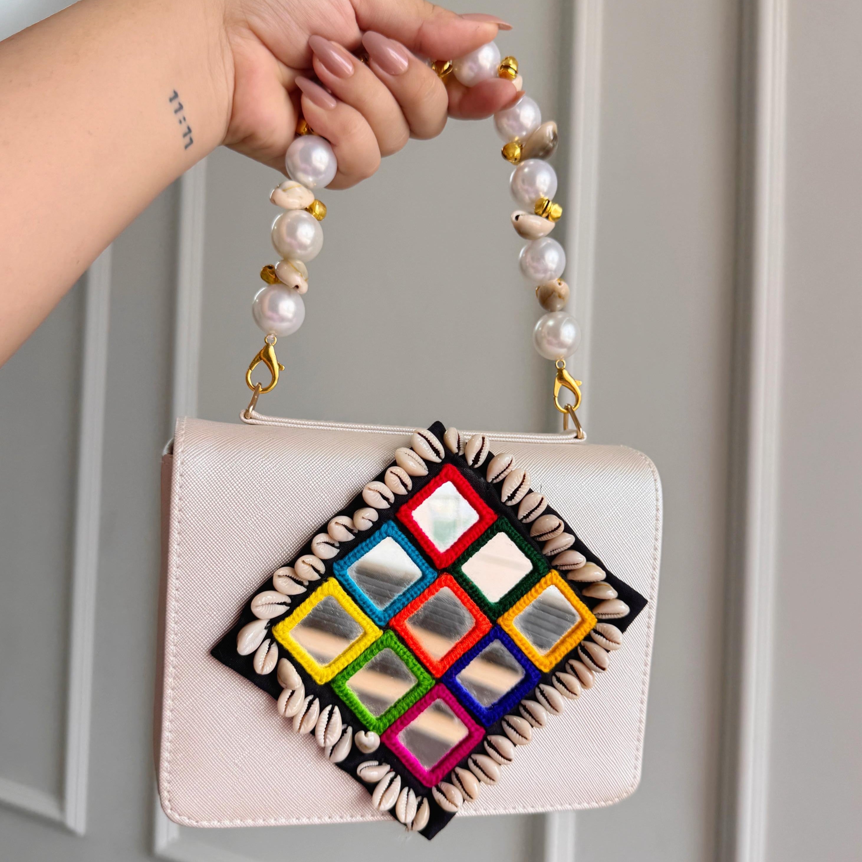 Designer Navratri Special Handcrafted Macro Bag – Multi-Mirror Embroidery, Cowrie Shell Edging & Pearl Handle Sling