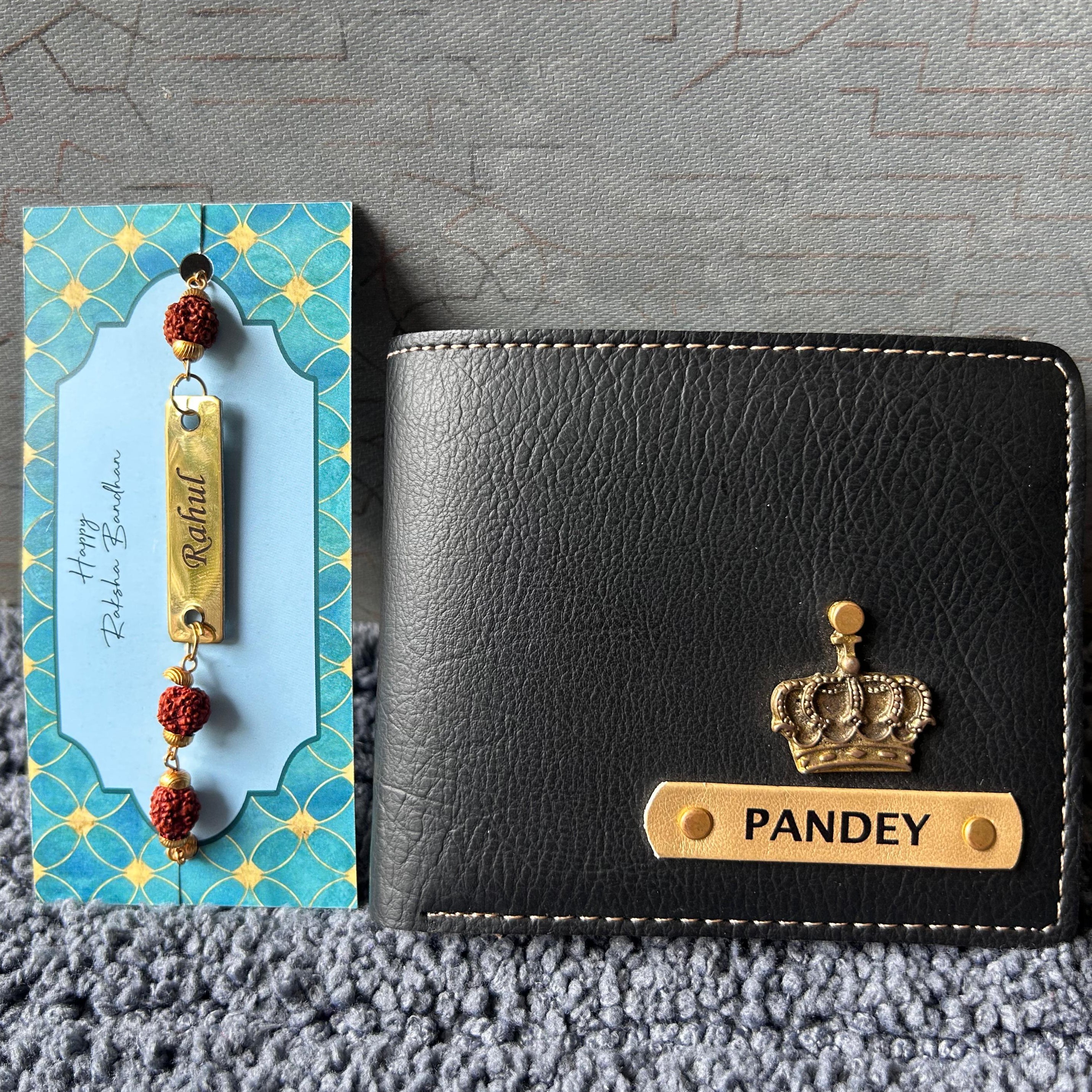 Black leather wallet with 'PANDEY' engraving and crown emblem on a textured surface.