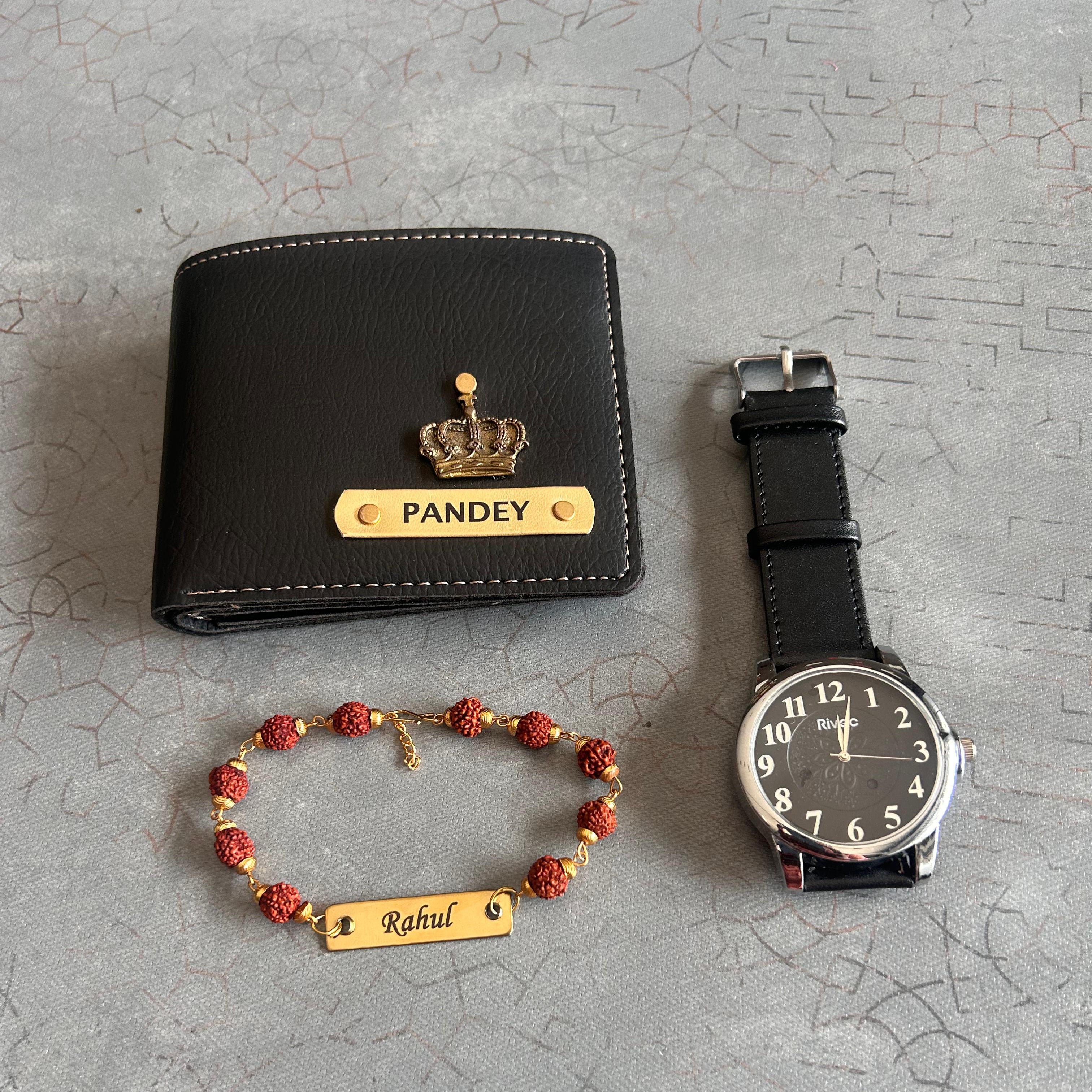Black wallet with 'Pandey' engraving, black watch, and bracelet on a textured gray surface