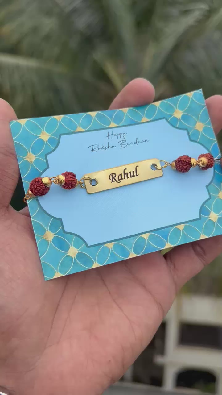 Personalised Rudraksh Rakhi - Raksha Bandhan Special - The Gifting Era - personalised rudraksh rakhi, rakhi with name engraving, raksha bandhan rakhi for brother, custom rakhi for bhaiya, rudraksh rakhi card packing, brass name rakhi, rakhi 2025 gift for brother, rakhi with metal plate, engraved rakhi online